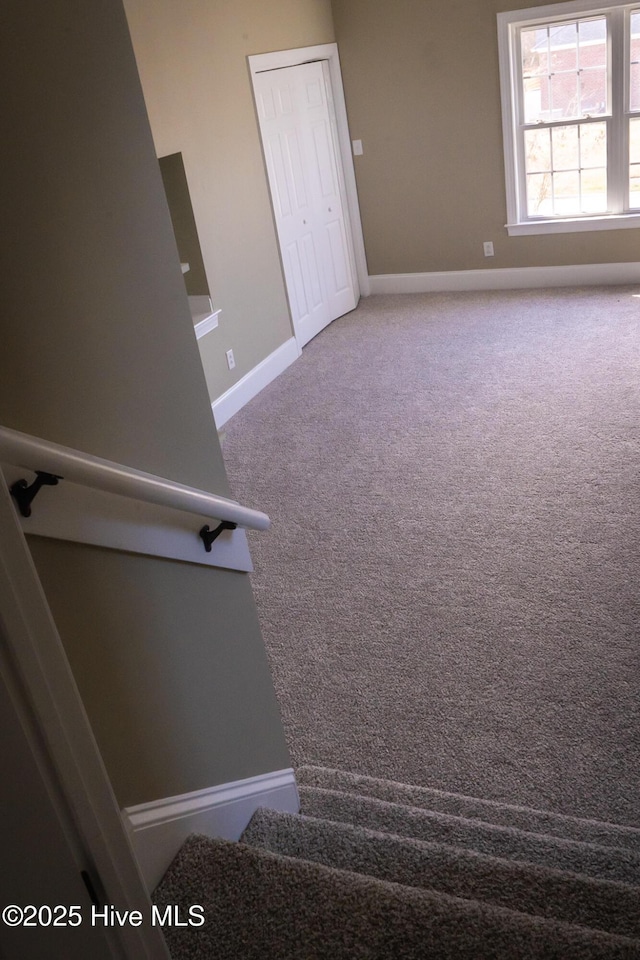 stairs featuring carpet flooring and baseboards