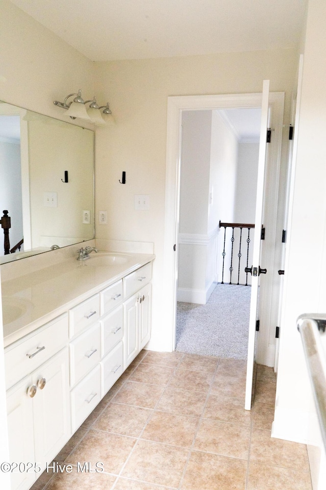 bathroom featuring tile patterned flooring, a sink, and double vanity