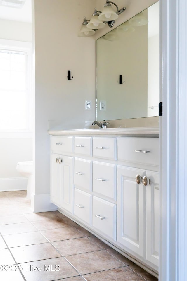 bathroom featuring tile patterned flooring and vanity