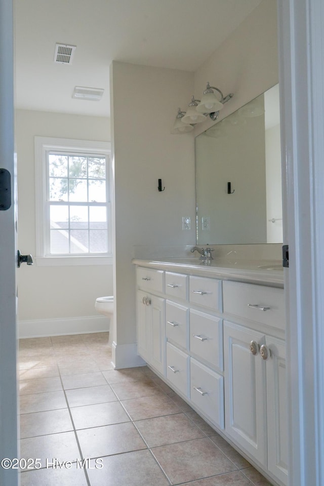 full bathroom with visible vents, baseboards, toilet, tile patterned flooring, and vanity