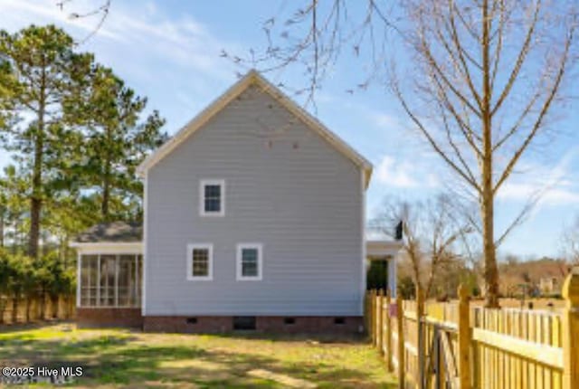 111 Wingate Dr, New Bern, NC 28562 - view of property exterior with a yard, a sunroom, a fenced backyard, and crawl space