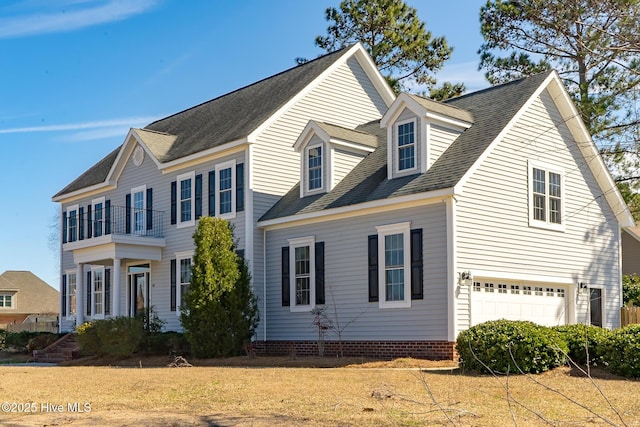 view of front of property with a shingled roof and an attached garage