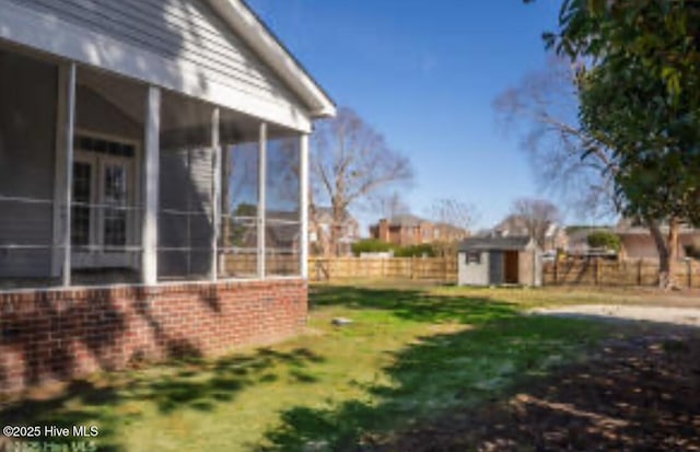 111 Wingate Dr, New Bern, NC 28562 - view of yard with an outdoor structure, a shed, a sunroom, and a fenced backyard