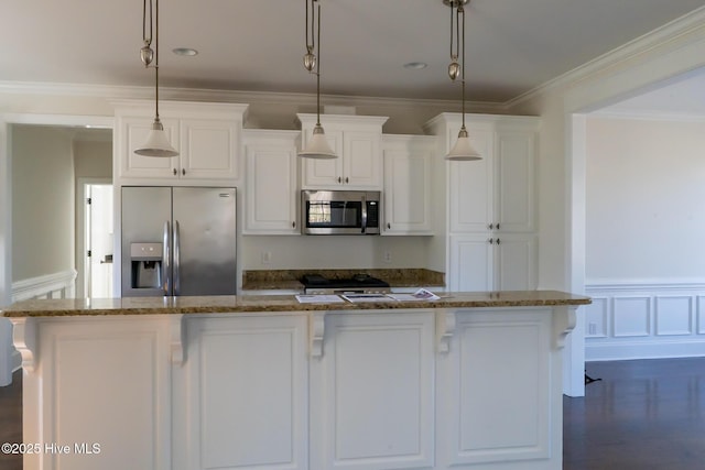 kitchen with stainless steel appliances, a center island, white cabinetry, and crown molding