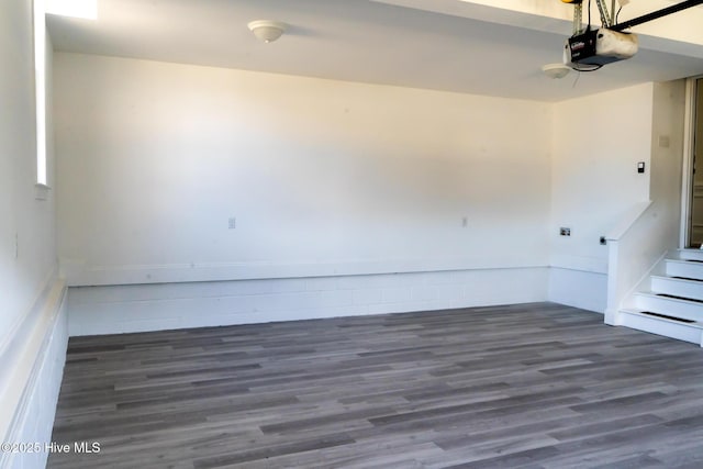 spare room featuring stairs and wood finished floors