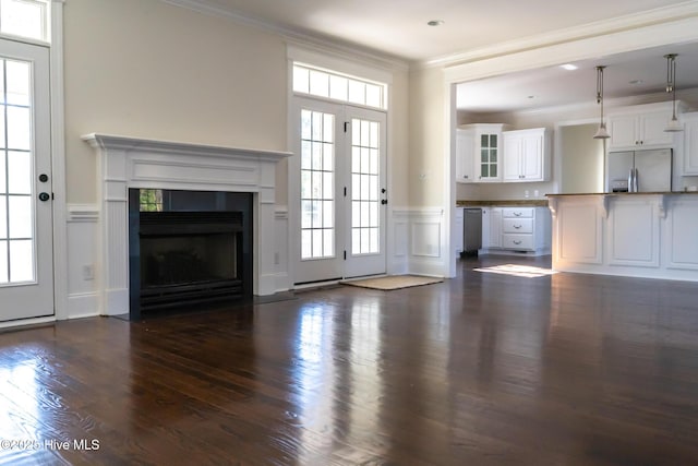 unfurnished living room featuring dark wood-style flooring, a fireplace with flush hearth, and crown molding