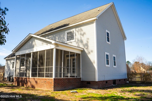 back of house featuring a sunroom, crawl space, and fence