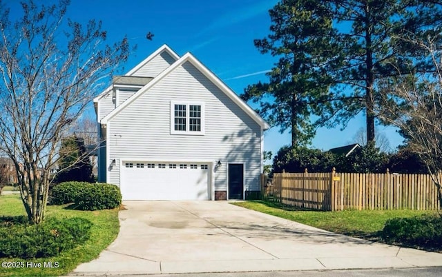 111 Wingate Dr, New Bern, NC 28562 - view of side of home featuring driveway, a garage, and fence