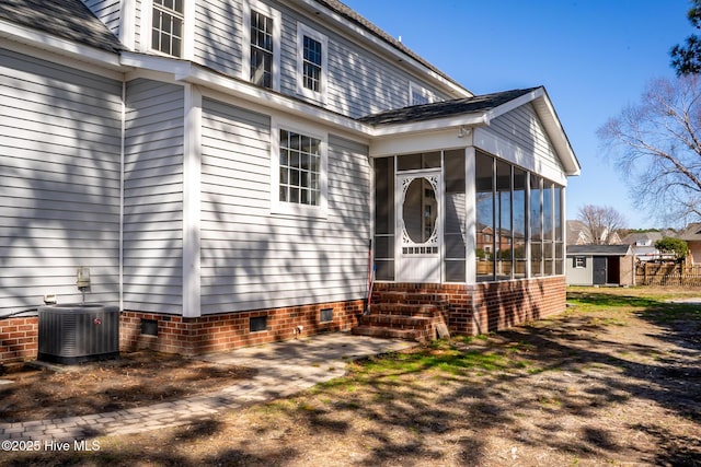 entrance to property featuring crawl space and central air condition unit