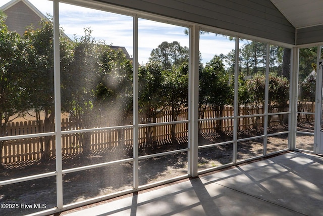 unfurnished sunroom with vaulted ceiling