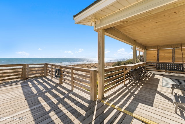 deck with a beach view and a water view