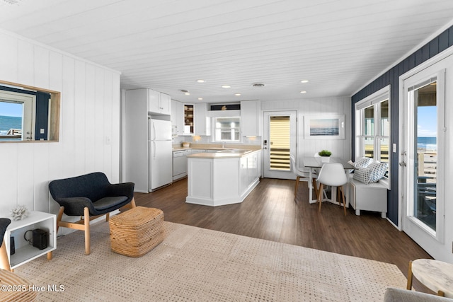 interior space featuring white appliances, white cabinets, dark wood-style floors, light countertops, and recessed lighting