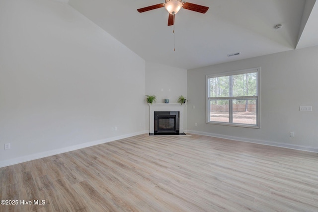 unfurnished living room featuring a fireplace with flush hearth, a ceiling fan, visible vents, baseboards, and light wood finished floors