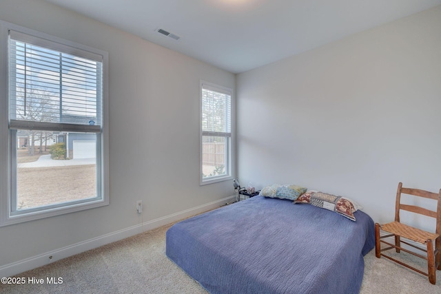 carpeted bedroom with baseboards and visible vents