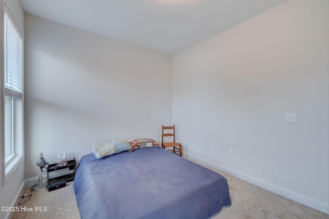 carpeted bedroom featuring baseboards