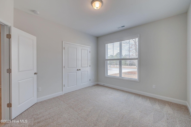 unfurnished bedroom featuring carpet and baseboards