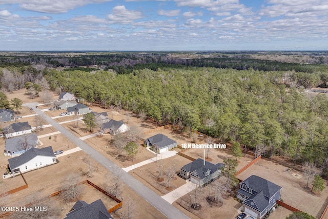 birds eye view of property with a wooded view