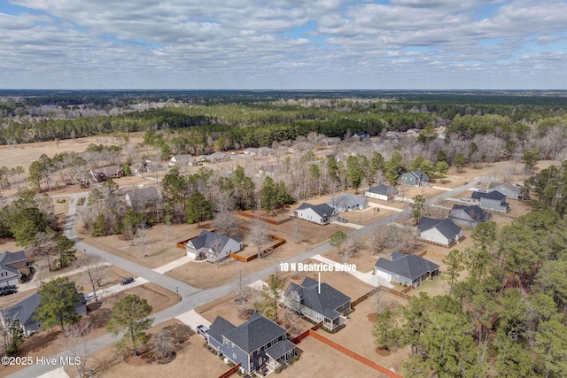 drone / aerial view with a residential view and a view of trees