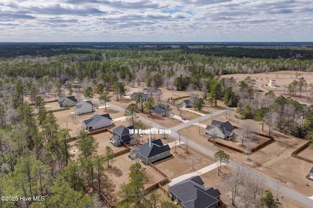 bird's eye view featuring a wooded view