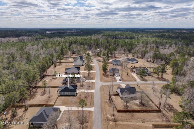 birds eye view of property with a forest view