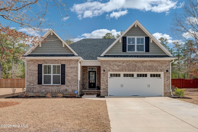 craftsman house featuring concrete driveway, brick siding, and fence