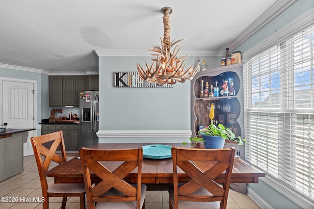 dining space with a healthy amount of sunlight, crown molding, and light tile patterned floors