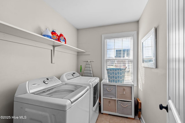 laundry room with washing machine and dryer, laundry area, and light tile patterned floors