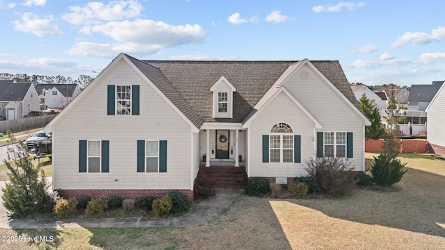 view of front of property featuring a front lawn, crawl space, a shingled roof, and fence