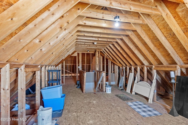 unfinished attic with an upstairs landing