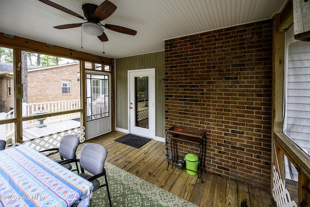 sunroom / solarium featuring a ceiling fan