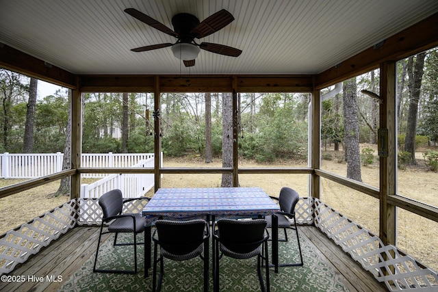 unfurnished sunroom with a healthy amount of sunlight and a ceiling fan