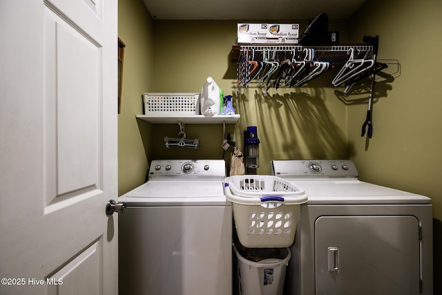 washroom featuring separate washer and dryer and laundry area