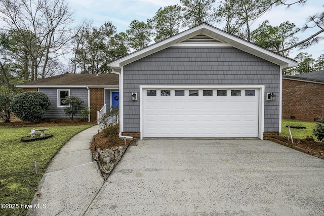 single story home with a garage, driveway, and a front yard