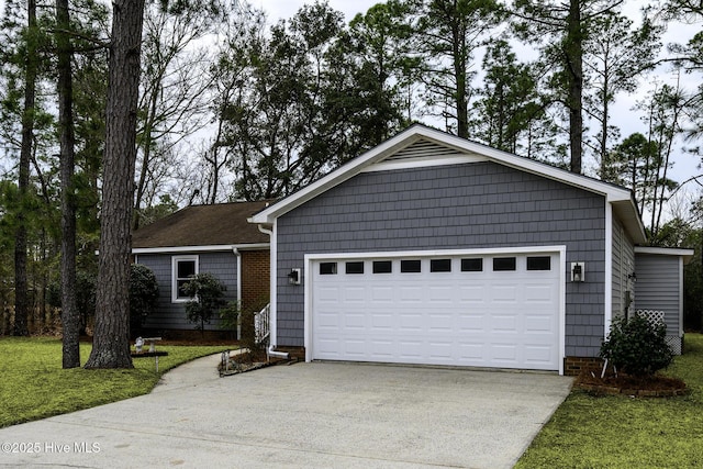 single story home featuring driveway, an attached garage, and a front yard