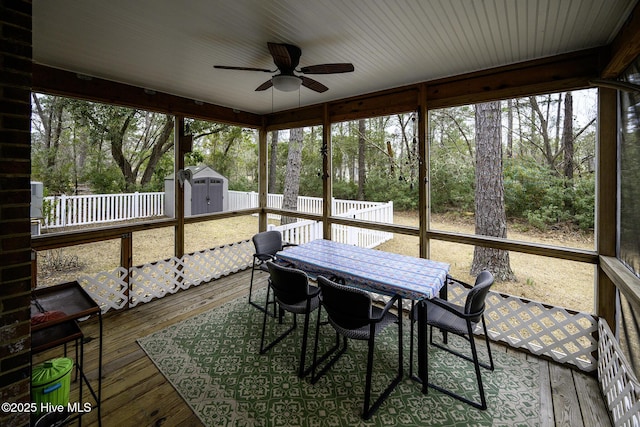 sunroom / solarium featuring a ceiling fan and a wealth of natural light