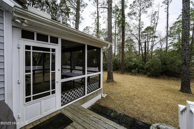 wooden deck featuring a sunroom