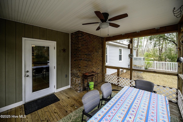 sunroom with a ceiling fan