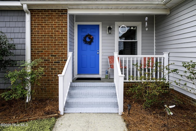 entrance to property featuring covered porch