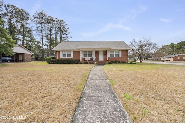 view of front of house with a front lawn and brick siding