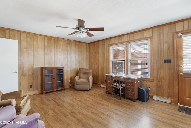 office featuring a ceiling fan, a wealth of natural light, visible vents, and wood finished floors