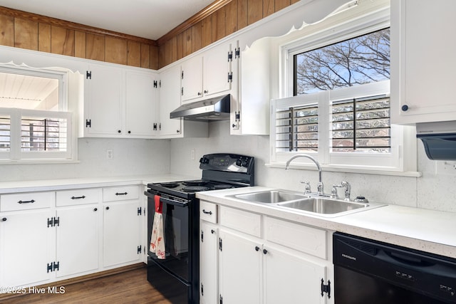 kitchen featuring light countertops, decorative backsplash, a sink, under cabinet range hood, and black appliances