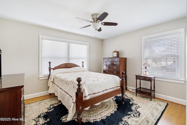 bedroom featuring ceiling fan, baseboards, and wood finished floors