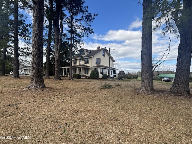 view of side of home featuring a chimney