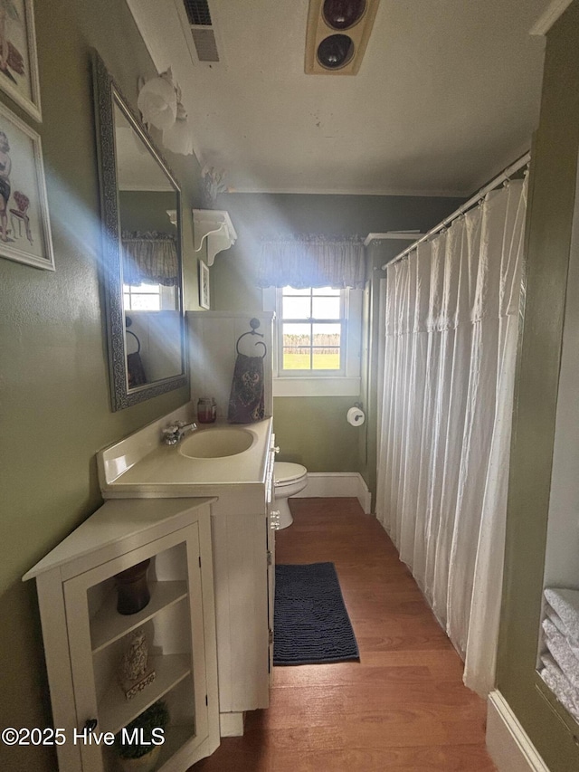 full bath with vanity, a shower with shower curtain, wood finished floors, and toilet