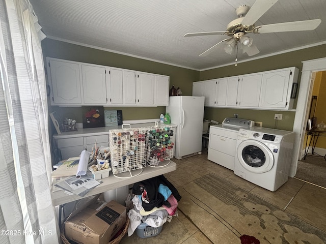 clothes washing area with ornamental molding, cabinet space, washing machine and clothes dryer, and a ceiling fan