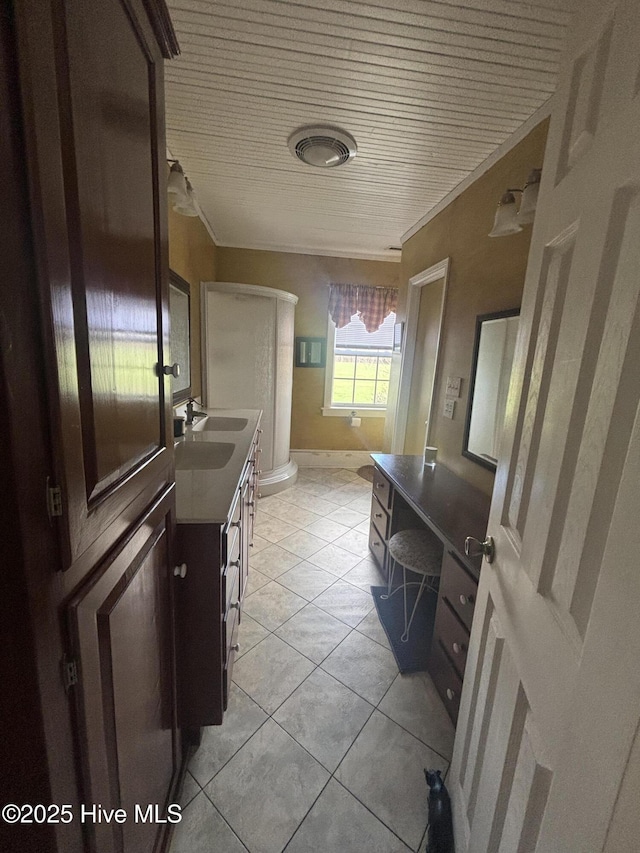 full bathroom featuring a shower, vanity, toilet, and tile patterned floors