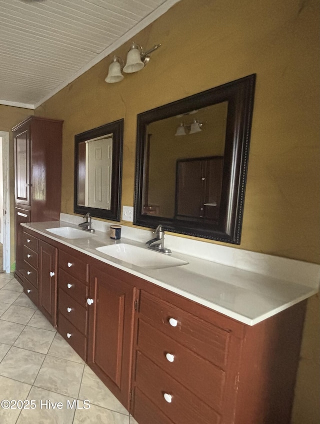 bathroom with double vanity, tile patterned flooring, and a sink