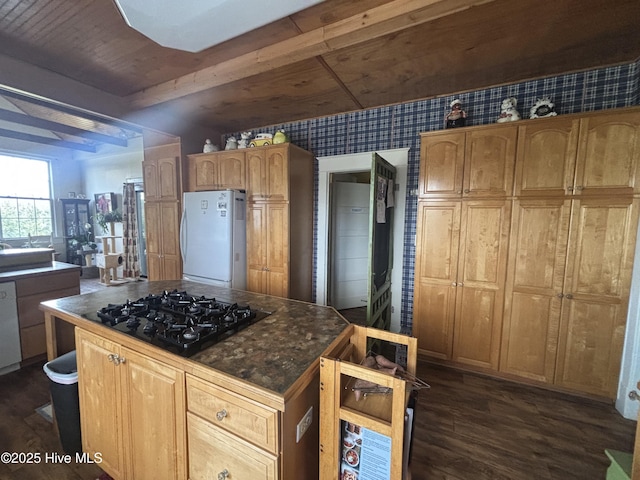 kitchen with black gas cooktop, dishwashing machine, freestanding refrigerator, a center island, and dark wood finished floors