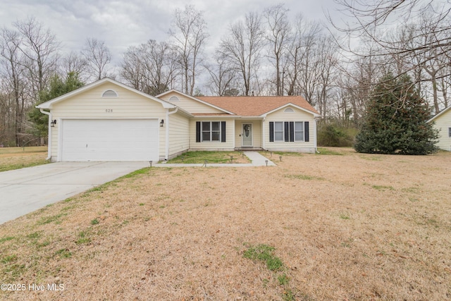 single story home with a front yard, an attached garage, and driveway