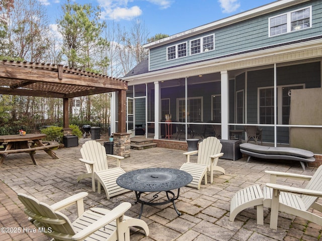 view of patio / terrace with a pergola and a sunroom